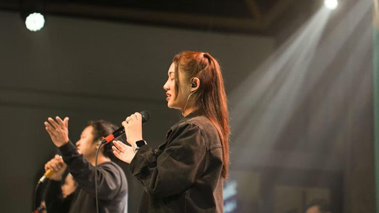 A singer performing on stage, avoiding common singing mistakes.